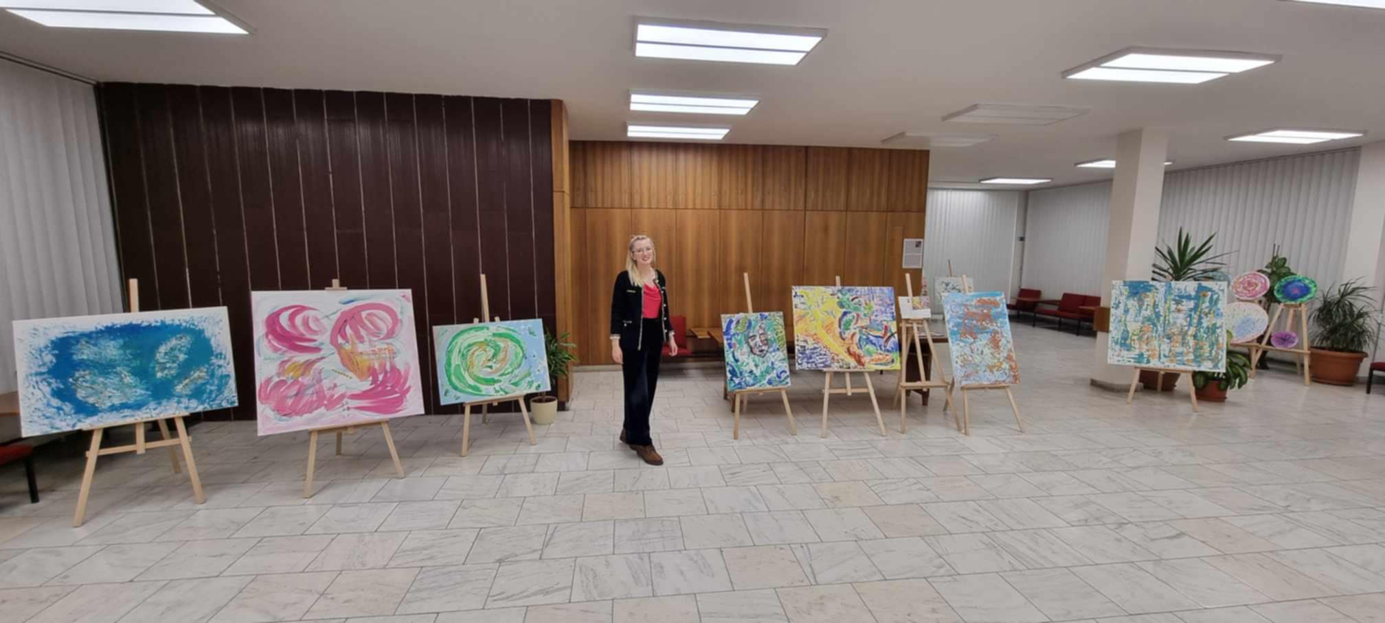 Monika Lionaitė su savo tapybos darbais